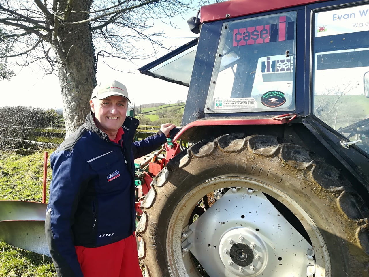Mr Watkin stands in front of his Case 885L tractor, shod with Mitas AC85 tires.